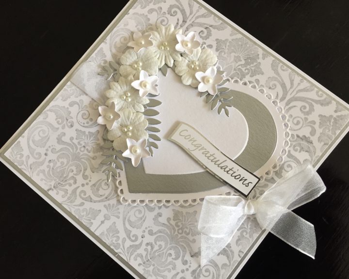Silver and white wedding card with hearts and flowers
