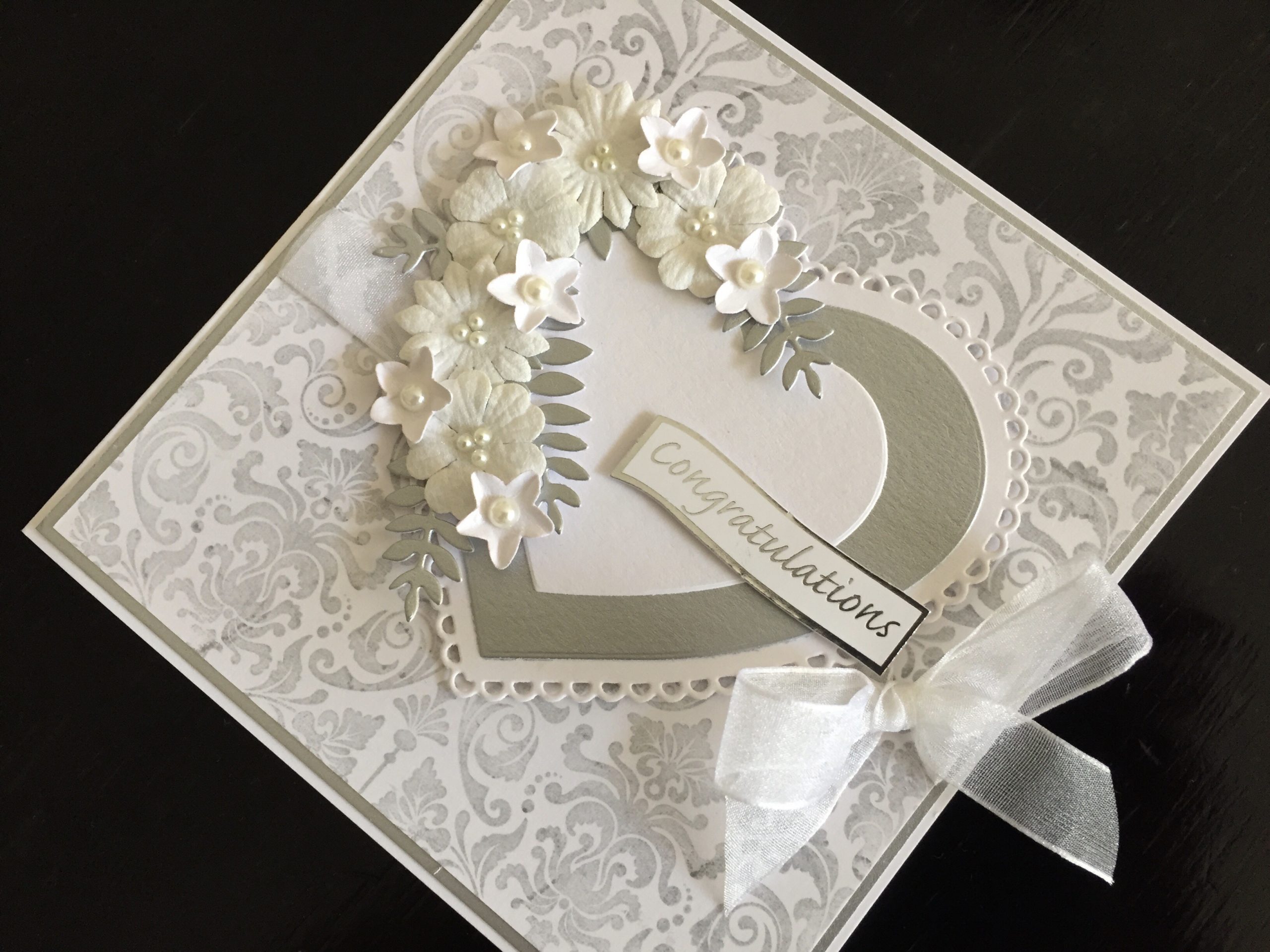 Silver and white wedding card with hearts and flowers