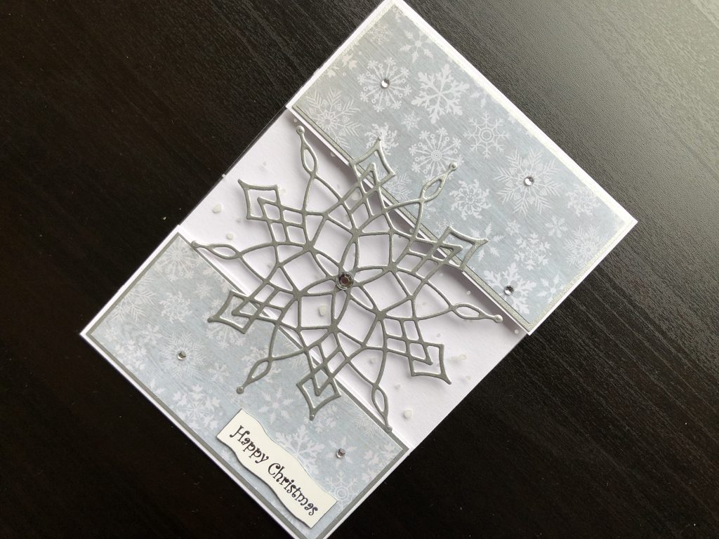 Hand made Christmas card with a die cut silver snowflake