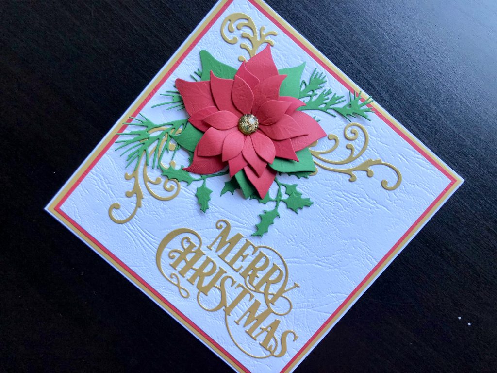 Hand made Christmas card with die cut poinsettia and merry Christmas greeting.