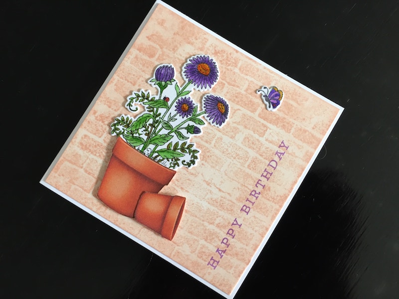 Hand made birthday card with stamped and die cut aster in a flower pot.
