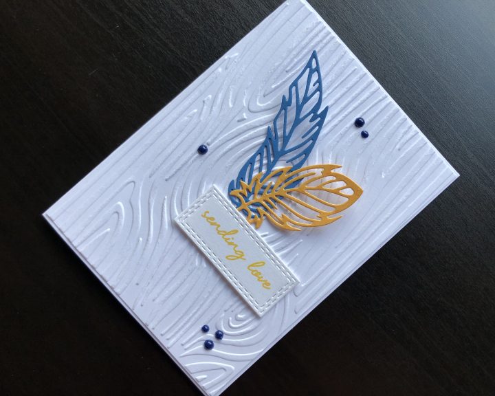 Hand made card with die cut feathers and woodgrain embossed background