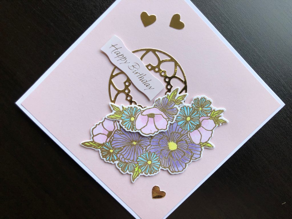 Hand made birthday card with stamped and die cut pastel flowers