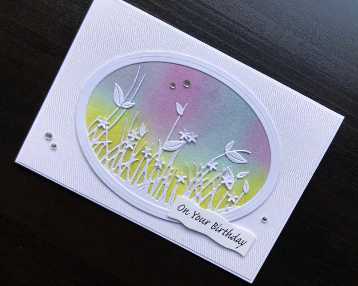 Hand made birthday card with inked background and die cut springtime border.