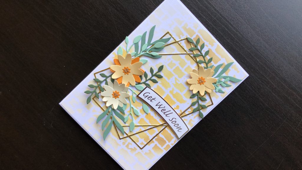 Hand made get well card with die cut flowers and frame with an inked background.