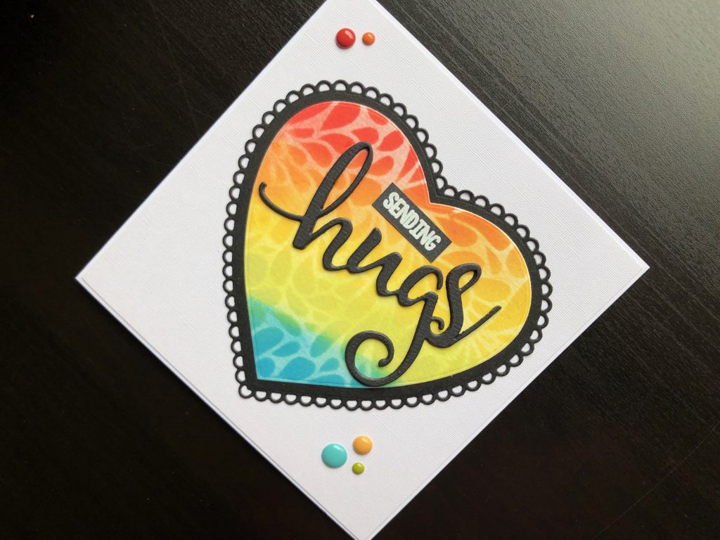 Hand made Hugs card with stencilled, die cut heart.