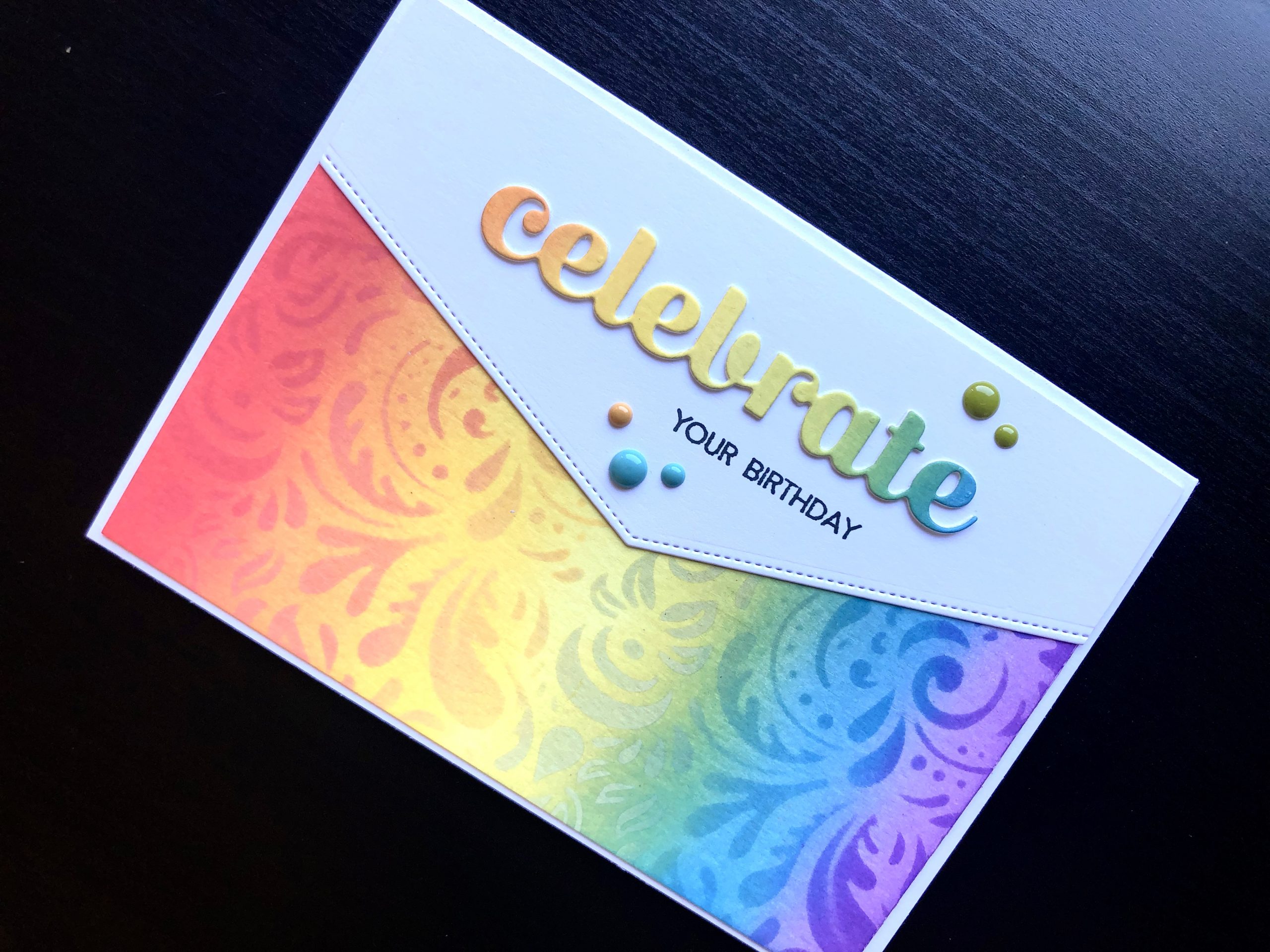 hand made birthday card with inked rainbow and die cut celebrate