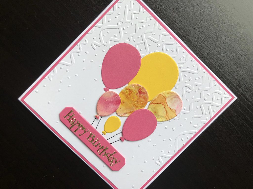 Hand made birthday card with embossed background and die cut balloons.