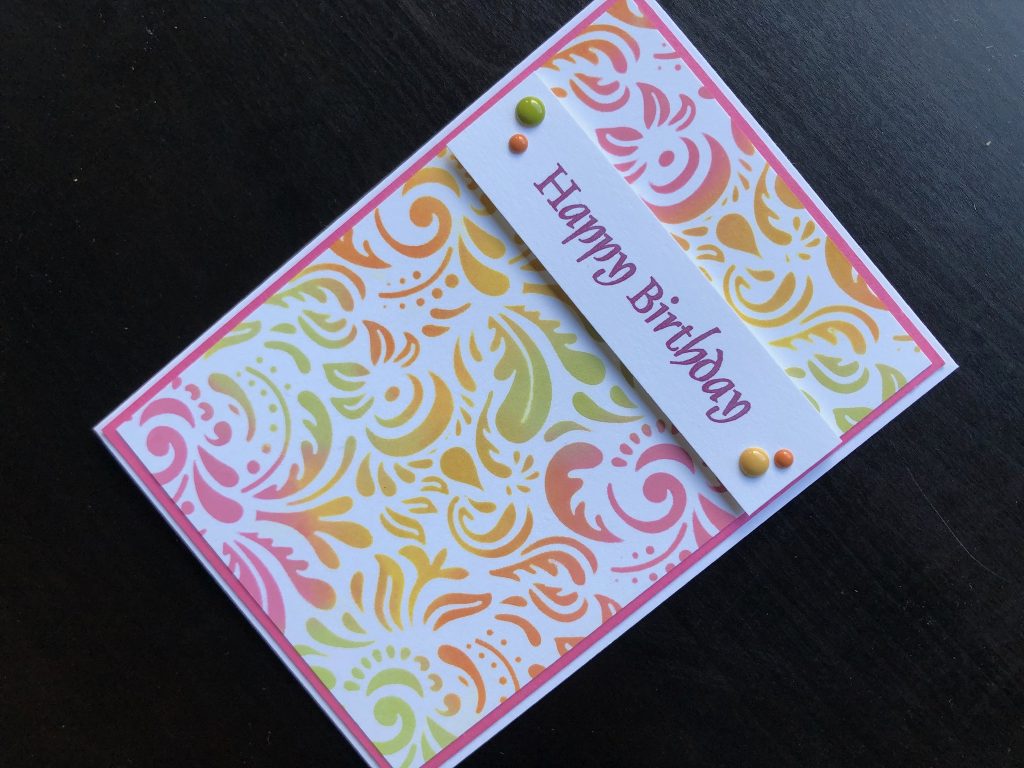 Hand made birthday card with stencilled background and stamped happy birthday greeting