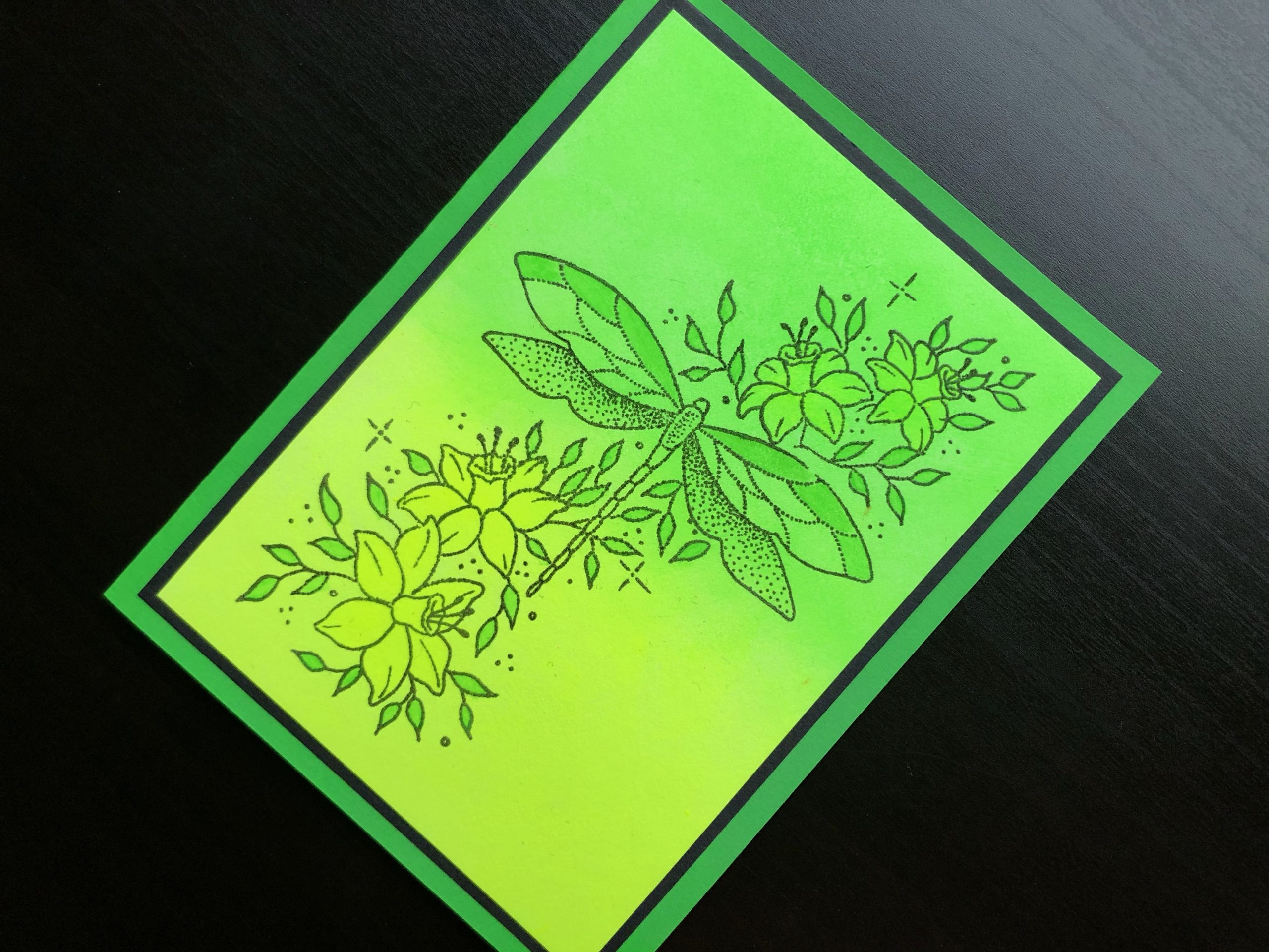 Hand made card with neon polish background and stamped dragonfly