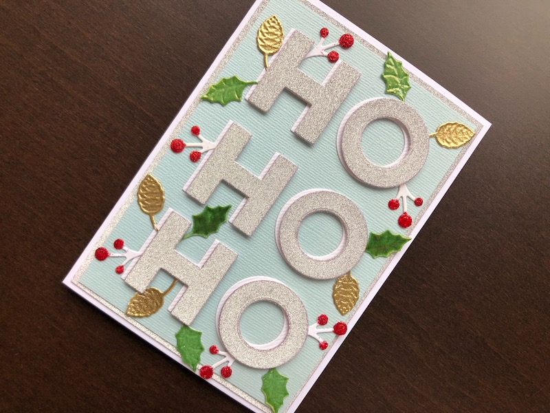Christmas card with die cut Ho Ho Ho and winter foliage