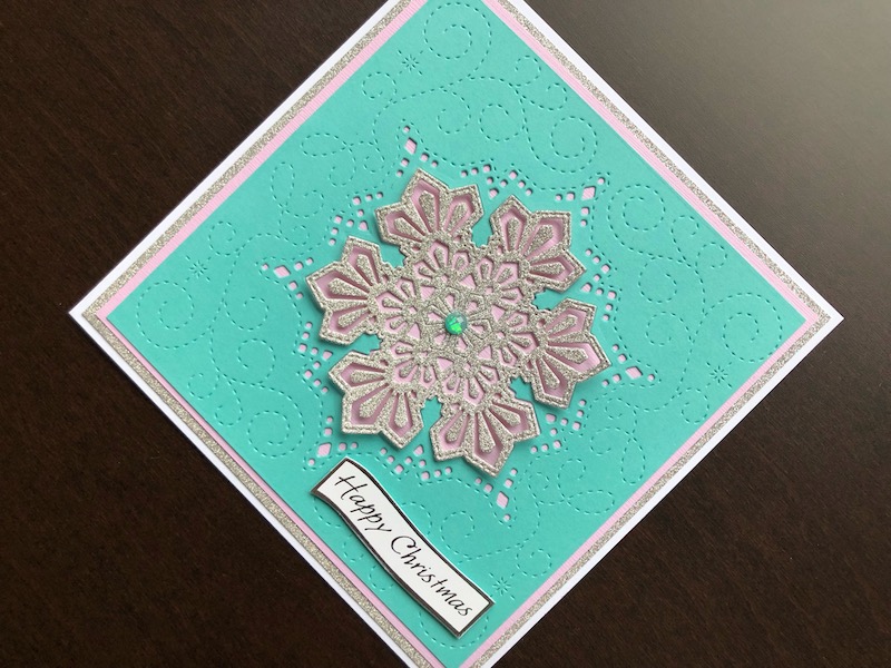 Hand made Christmas card with die cut layered snowflake background