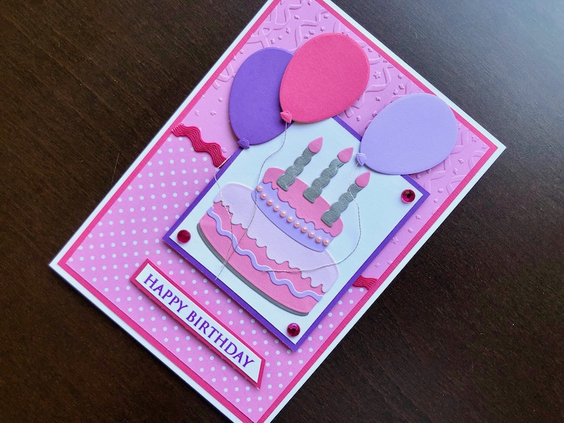 Hand made birthday card with die cut cake, candles and balloons