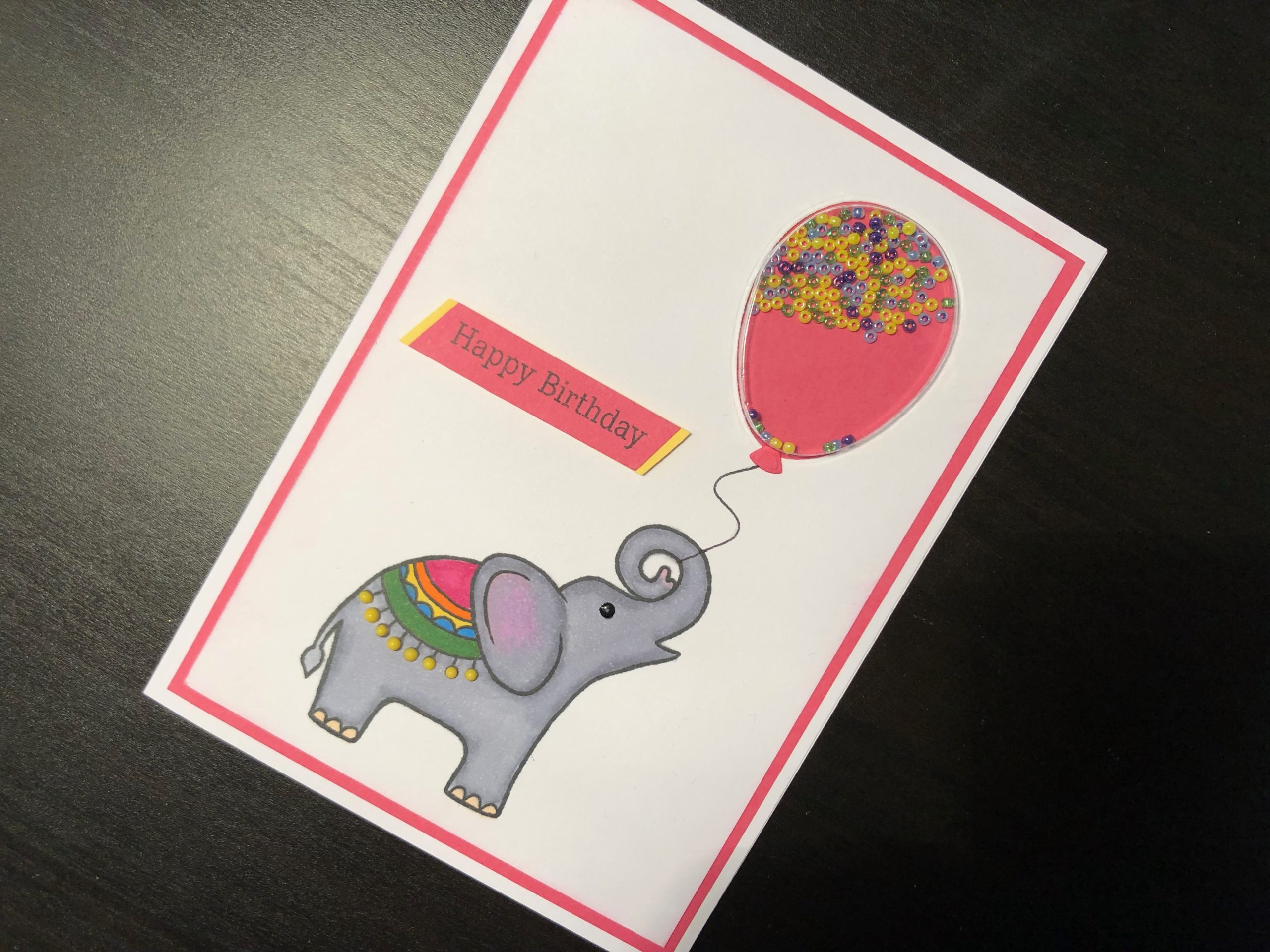 Hand made birthday card with balloon shaker and baby elephant
