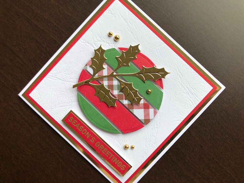 Hand made Christmas card with floating element and die cut holly leaves