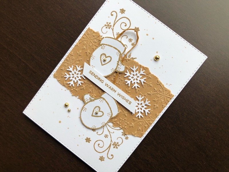 Hand made Christmas card with stamped, fussy cut mittens and embossed background panel