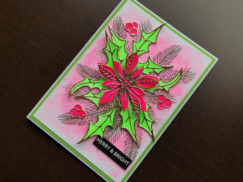 Hand made Christmas card with neon coloured poinsettia and holly