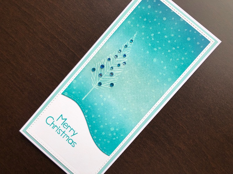 Hand made Christmas card with inked, die cut background and stamped twiggy tree with crystals