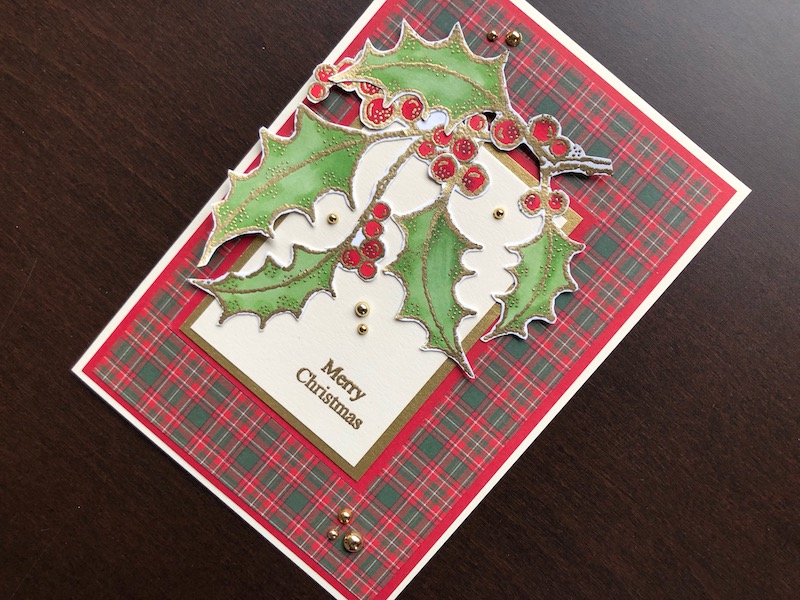 Hand made Christmas card with stamped and fussy cut holly sprays and tartan background