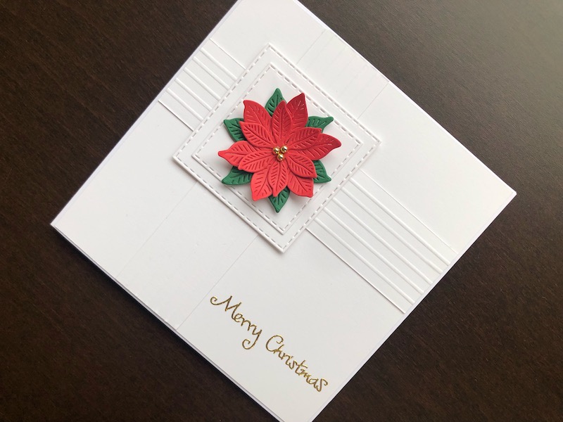 Hand made Christmas card with decorative score lines and die cut poinsettia