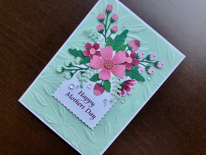 Hand made Mothers Day card with die cut flowers and embossed leafy background