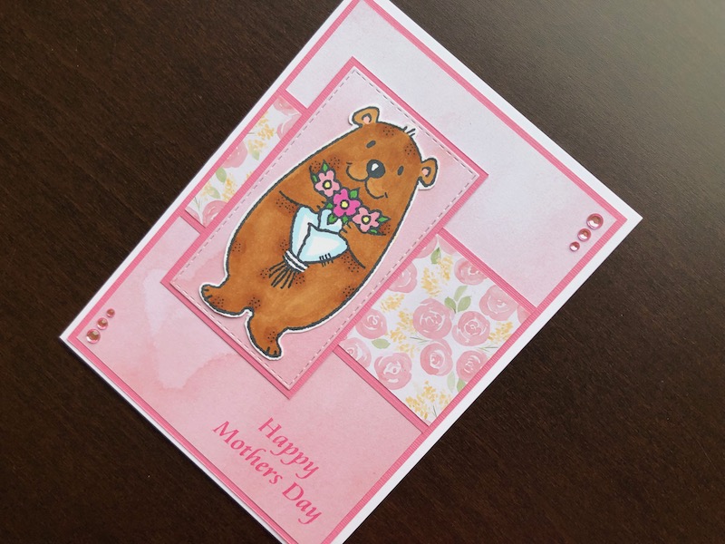 Hand made Mothers Day card with stamped Flower Bear and pink background.