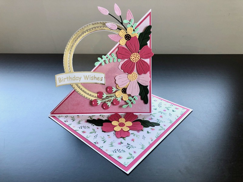 Hand made twisted easel card with die cut circle frames and flowers.