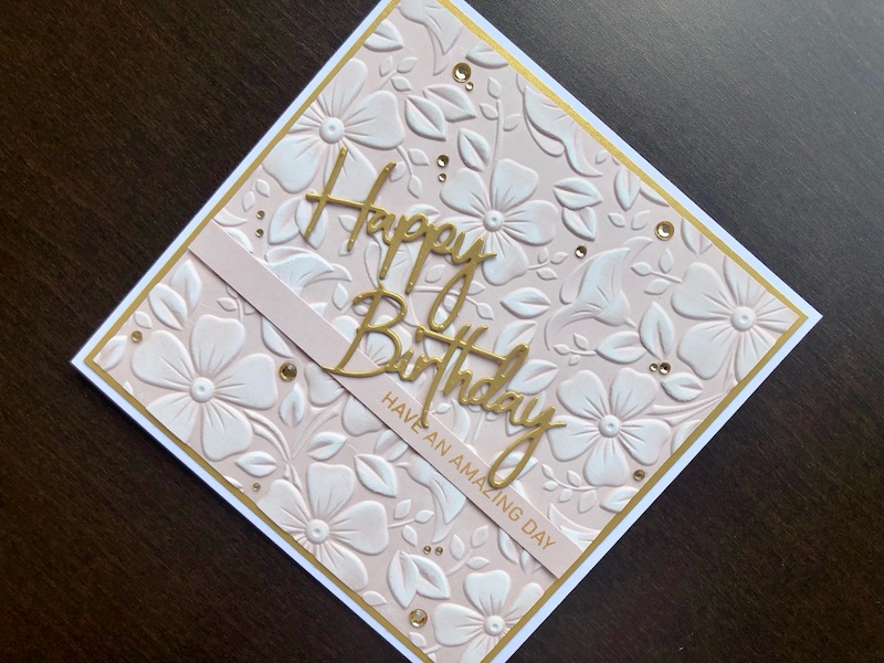 Hand made birthday card with embossed background, highlighted with white ink and die cut sentiment