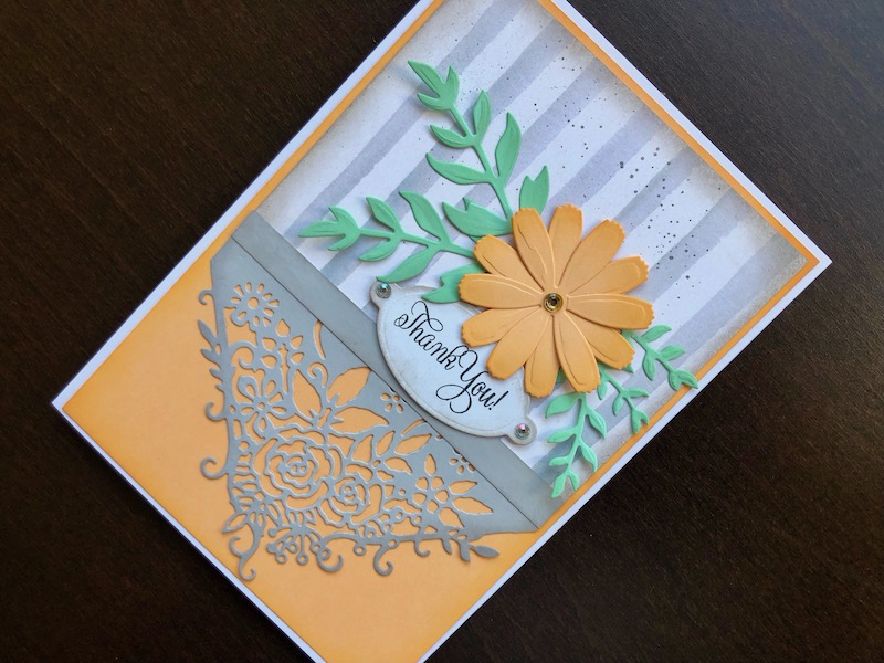 Hand made thank you card with die cut flower and decorative panel and striped background paper.