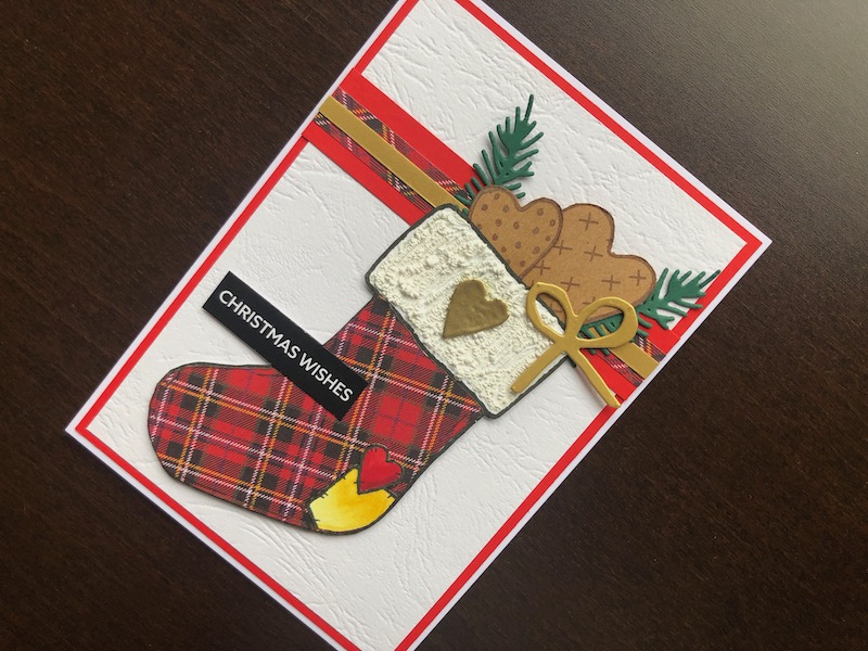 Hand made Christmas card with tartan paper pieced stocking and stamped cookies.