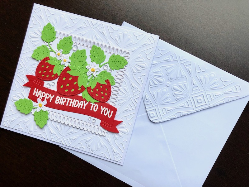 Hand made birthday card with die cut strawberries, embossed background and matching embossed envelope.