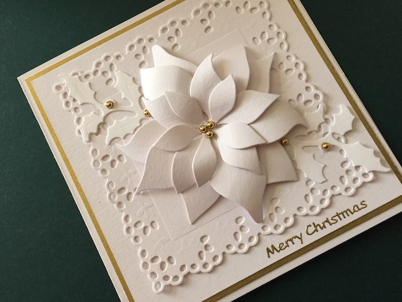 White and gold hand made Christmas card with die cut poinsettia and frame