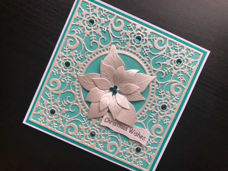 Christmas card with ice crystal die cut background and poinsettia