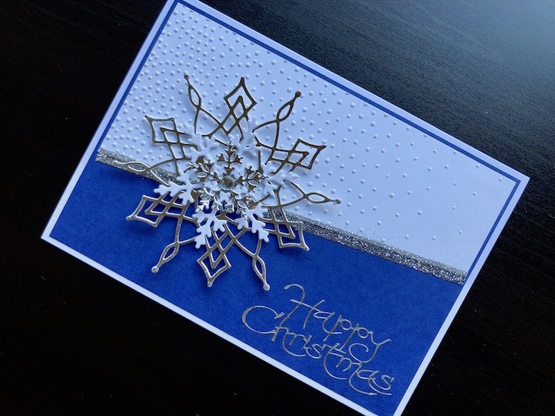 Christmas card with embossed background and die cut snowflakes
