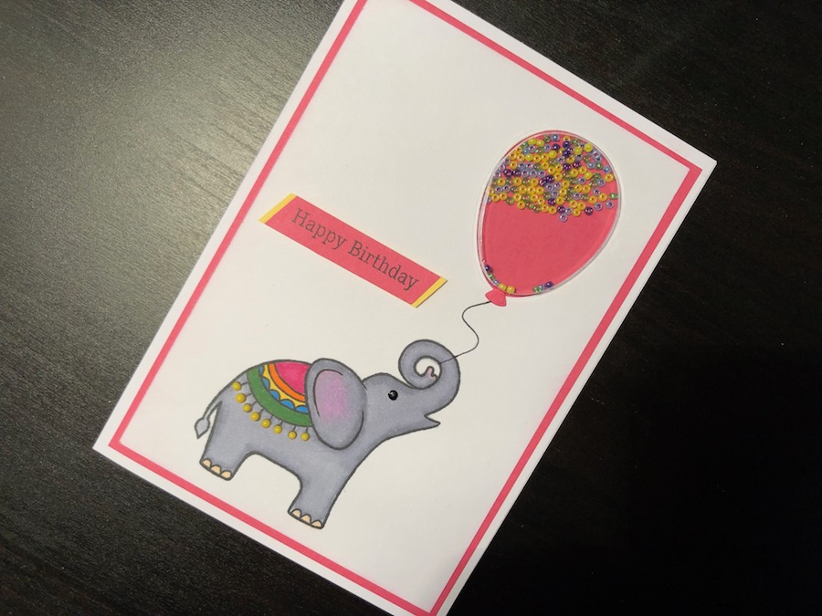 Balloon shaker card with stamped elephant and Nuvo Drops